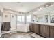 Bright bathroom with a glass shower, soaking tub, and double vanity with granite countertops at 10811 Chambers Way, Commerce City, CO 80022
