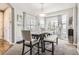 Cozy dining area filled with natural light, neutral decor, and a charming bay window with garden views at 10811 Chambers Way, Commerce City, CO 80022