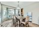 Bright dining room with elegant lighting, neutral color scheme, and large bay window with charming window treatments at 10811 Chambers Way, Commerce City, CO 80022