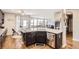 Open-concept kitchen showcasing granite countertops, stainless steel appliances, and views into the bright living area at 10811 Chambers Way, Commerce City, CO 80022