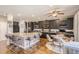Spacious kitchen features a large center island, sleek black cabinetry, and modern stainless steel appliances at 10811 Chambers Way, Commerce City, CO 80022