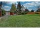 Large, grassy backyard featuring a swing set and shed, perfect for Gathering fun at 4391 W Tufts Ave, Denver, CO 80236