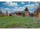Backyard of the property showing the building's exterior, lawn and shed at 4391 W Tufts Ave, Denver, CO 80236