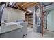 Basement laundry area with washer, dryer, sink, storage shelves, and utility connections at 4391 W Tufts Ave, Denver, CO 80236
