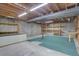 Unfinished basement with exposed wood ceiling and concrete walls, providing lots of storage space at 4391 W Tufts Ave, Denver, CO 80236
