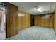 Retro basement rec room with wood paneling, drop ceiling, and vintage carpet at 4391 W Tufts Ave, Denver, CO 80236