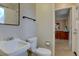 Well-maintained bathroom with vanity and shower-tub combination featuring tiled walls and convenient grab bars at 4391 W Tufts Ave, Denver, CO 80236