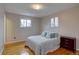 Cozy bedroom with hardwood floors, lots of natural light, and a comfortable queen-sized bed with stylish accent pillows at 4391 W Tufts Ave, Denver, CO 80236