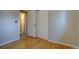 Cozy bedroom with wood floors, closet and view into the attached bathroom at 4391 W Tufts Ave, Denver, CO 80236