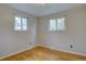 Bright bedroom featuring hardwood floors and natural light streaming through two windows, creating a peaceful ambiance at 4391 W Tufts Ave, Denver, CO 80236