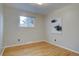 Inviting bedroom with hardwood floors, perfect for relaxation, accented by an artwork and a view from the window at 4391 W Tufts Ave, Denver, CO 80236