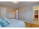 Comfortable bedroom featuring hardwood floors and ample closet space, with easy access to an en-suite bathroom at 4391 W Tufts Ave, Denver, CO 80236