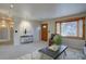 Bright living room with a large bay window, neutral carpet and comfortable seating at 4391 W Tufts Ave, Denver, CO 80236