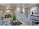 View of a well-lit living room connecting to the dining area and adjacent spaces at 4391 W Tufts Ave, Denver, CO 80236