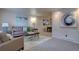 Cozy living room featuring neutral tones, modern art, and comfortable seating arrangements at 4391 W Tufts Ave, Denver, CO 80236