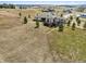 Aerial view of a home with a large, fenced yard and mature trees in a rural setting at 2937 Hidden Den Ct, Franktown, CO 80116