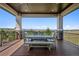 Outdoor covered patio featuring wood-look floorboards and a picturesque view at 2937 Hidden Den Ct, Franktown, CO 80116