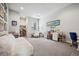 Large carpeted craft room with storage, desk, and comfortable seating area at 2937 Hidden Den Ct, Franktown, CO 80116