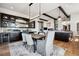 Dining area with a rustic table, modern light fixture, and seamlessly connected to the kitchen area at 2937 Hidden Den Ct, Franktown, CO 80116