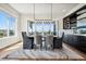 Dining room with hardwood floors, modern lighting, and big windows with views at 2937 Hidden Den Ct, Franktown, CO 80116