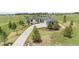 Beautiful house with gray roof and long concrete driveway, surrounded by mature trees at 2937 Hidden Den Ct, Franktown, CO 80116