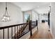 Hallway with wood floors, staircase, pendant lighting, and a view at 2937 Hidden Den Ct, Franktown, CO 80116