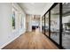 Hallway with wooden floors and sliding glass doors and windows to the backyard at 2937 Hidden Den Ct, Franktown, CO 80116