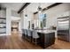 Spacious kitchen with an island, granite countertops, hardwood floors, and modern stainless appliances at 2937 Hidden Den Ct, Franktown, CO 80116