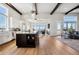 Open kitchen and living space with vaulted ceiling and exposed beams at 2937 Hidden Den Ct, Franktown, CO 80116