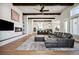 Open floor plan view of living room and kitchen, with hardwood floors, and beamed ceilings at 2937 Hidden Den Ct, Franktown, CO 80116