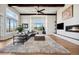 Spacious living room with a fireplace, beamed ceilings, hardwood flooring, and large windows at 2937 Hidden Den Ct, Franktown, CO 80116