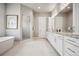 Bright bathroom with double vanity sinks, tub, and walk-in shower at 2937 Hidden Den Ct, Franktown, CO 80116