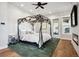 Bright main bedroom with canopy bed, fireplace, and hardwood floors at 2937 Hidden Den Ct, Franktown, CO 80116