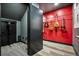 Soundproofed music room with instruments hanging on the wall and a sleek black door at 2937 Hidden Den Ct, Franktown, CO 80116