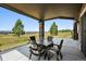 Outdoor patio with seating area, stone pillars, and a beautiful view of the surrounding landscape at 2937 Hidden Den Ct, Franktown, CO 80116
