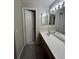 Bathroom featuring a vanity with storage and a large mirror at 2242 S Uravan St, Aurora, CO 80013