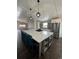 Modern kitchen featuring a large island with seating, stainless steel appliances, and ample cabinet space at 2242 S Uravan St, Aurora, CO 80013