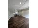 Open-concept living space with wood-look floors, vaulted ceilings, and open access to kitchen at 2242 S Uravan St, Aurora, CO 80013