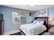 Comfortable bedroom with a large window letting in natural light and stylish decor at 4673 Perth St, Denver, CO 80249