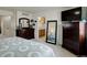 Bright bedroom with dressers, mirrors, and a glimpse into the ensuite bathroom at 4673 Perth St, Denver, CO 80249