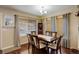 Elegant dining room with a large table, chandelier, and natural light creating an inviting atmosphere for meals at 4673 Perth St, Denver, CO 80249
