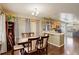 Open concept dining and kitchen area perfect for entertaining, featuring elegant furnishings and hardwood floors at 4673 Perth St, Denver, CO 80249