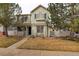 Inviting home with a cozy porch, xeriscaped front yard, and mature trees offering shade and curb appeal at 4673 Perth St, Denver, CO 80249