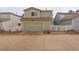 Home exterior showcasing a two-car garage with a well-maintained driveway and fenced yard at 4673 Perth St, Denver, CO 80249
