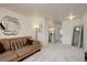 Spacious hallway reveals an upper floor living room and a stairway at 4673 Perth St, Denver, CO 80249