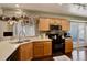 Functional kitchen features wooden cabinets, modern appliances, and ample counter space for food preparation at 4673 Perth St, Denver, CO 80249