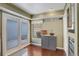Cozy kitchenette area with a cabinet, French doors to the patio, and hardwood floors for easy maintenance at 4673 Perth St, Denver, CO 80249