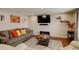 Comfortable living room with hardwood floors, modern decor, a decorative fireplace, and ample seating for guests at 4673 Perth St, Denver, CO 80249