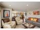 Inviting living room open to the kitchen features hardwood floors and comfortable seating at 4673 Perth St, Denver, CO 80249