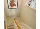 Carpeted stairway featuring a landing and artwork, leading to the upper level at 4673 Perth St, Denver, CO 80249